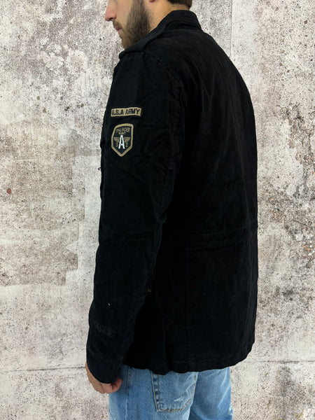 Field jacket nera con patch e rotture