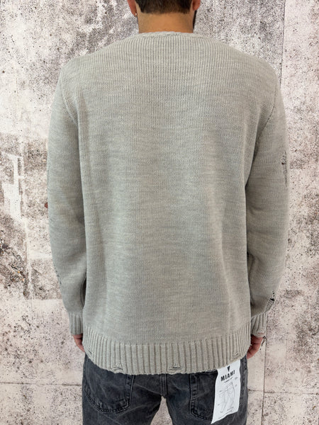 Maglione sabbia rotture e cuciture